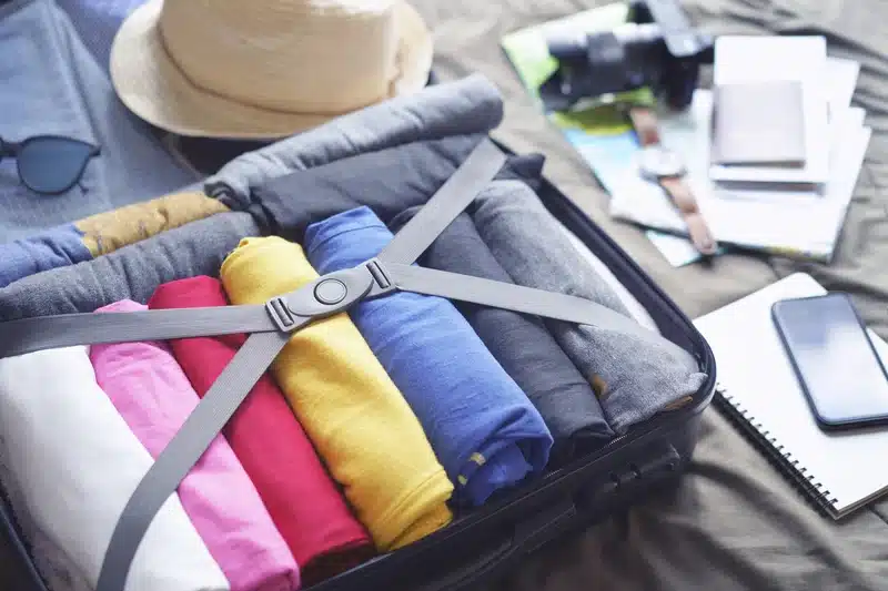 A packed suitcase and travel documents for a patient preparing to travel for inpatient addiction treatment