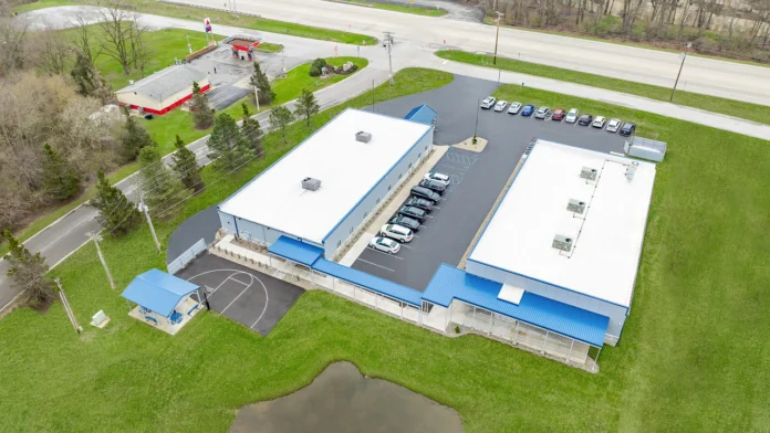 Aerial view of the Boca Recovery Center facility in Huntington, IN featuring basketball court and pond