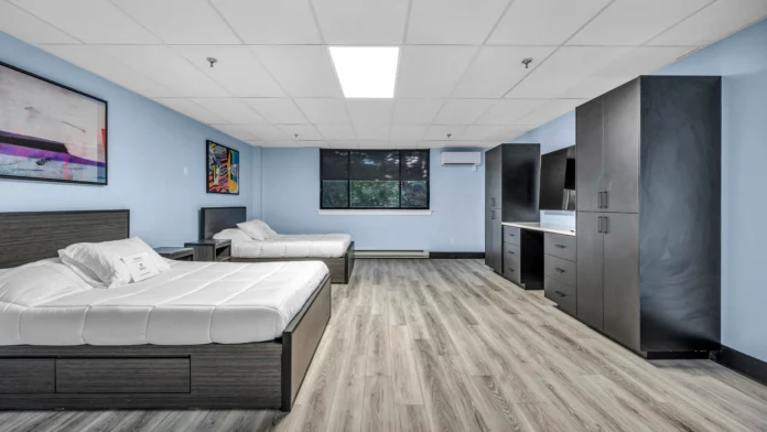 Luxury resident bedroom with plush bedding in Boca Recovery Center Springfield, Massachusetts treatment center.