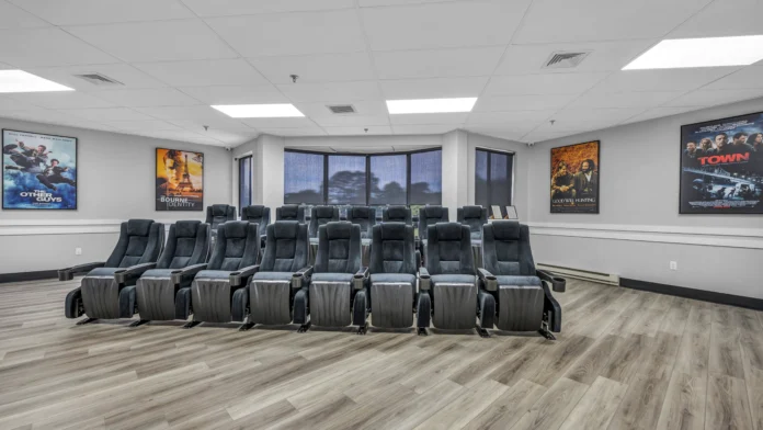 Front view of in-house movie theater with tiered recliners at Boca Recovery Center, Springfield, MA.